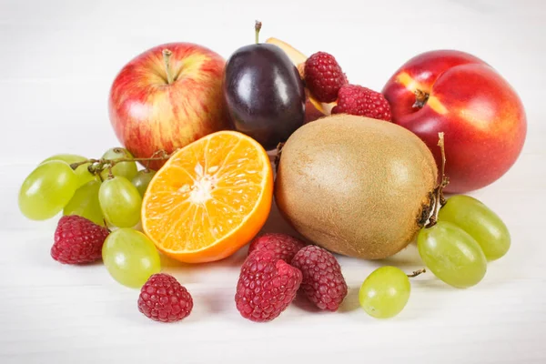 Frische reife Früchte auf weißen Tafeln, gesunde Ernährung — Stockfoto