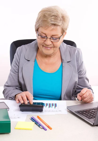 Mujer de negocios de edad avanzada que trabaja en su escritorio en la oficina, análisis del plan de ventas, concepto de negocio — Foto de Stock