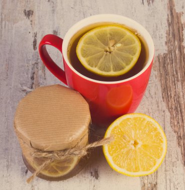 Vintage Fotoğraf, bal ile taze limon ve çay üzerinde ahşap masa, sağlıklı beslenme