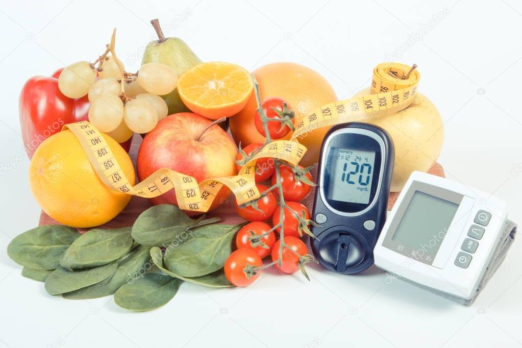Glucometer, blood pressure monitor, fruits with vegetables and centimeter, healthy lifestyle
