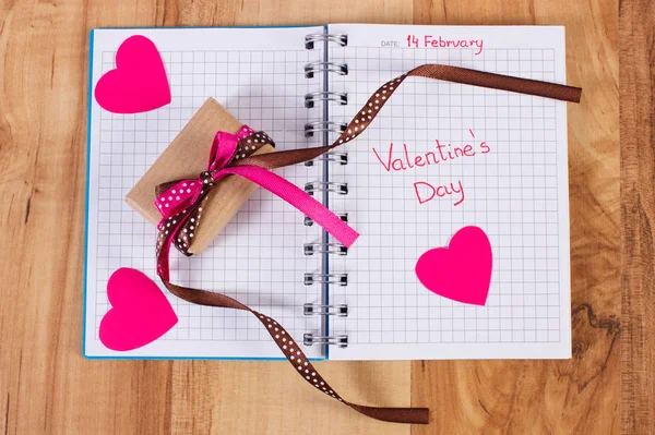San Valentino scritto nel taccuino, regalo avvolto e cuori, decorazione per San Valentino — Foto Stock