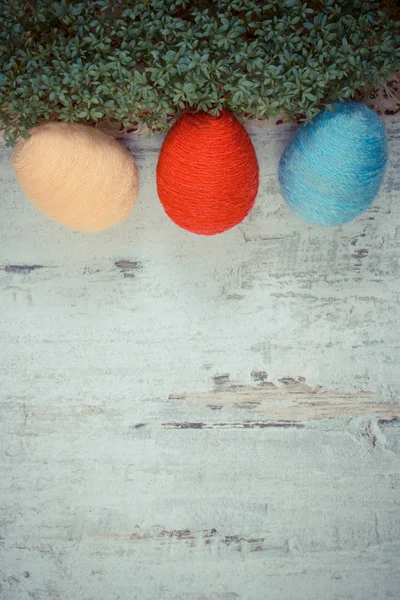 Paskalya yumurtaları yün dize ve yeşil cress ahşap arka plan, metin, Paskalya için dekorasyon için kopya yer üzerine sarılmış — Stok fotoğraf