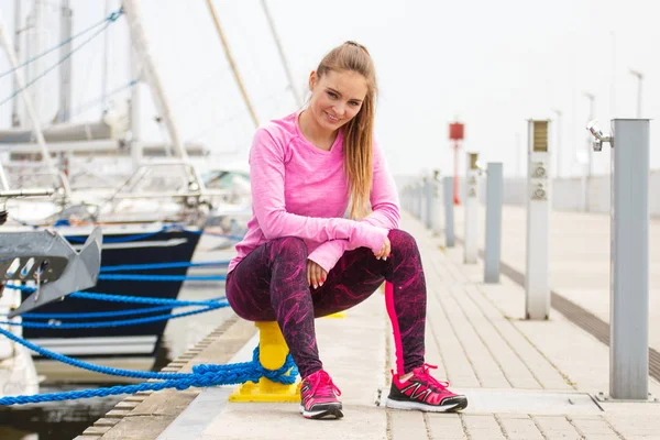 Chica delgada en ropa deportiva descansando después del ejercicio en el puerto, estilo de vida activo saludable — Foto de Stock