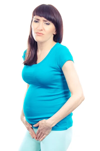 Mujer embarazada triste con las manos en el estómago, cuidado de la salud del embarazo y dolores de vejiga — Foto de Stock
