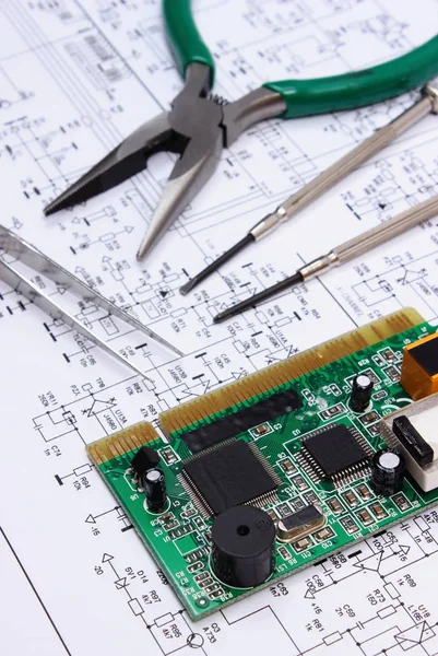 Printed circuit board and precision tools on diagram of electronics, technology — Stock Photo, Image