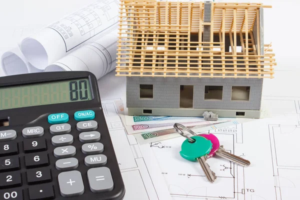 House under construction, keys, calculator, polish currency and electrical drawings, concept of building home — Stock Photo, Image