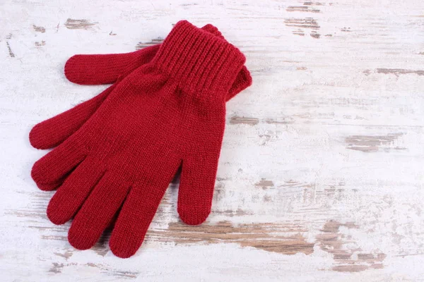 Pair of woolen gloves for woman on old wooden background — Stock Photo, Image