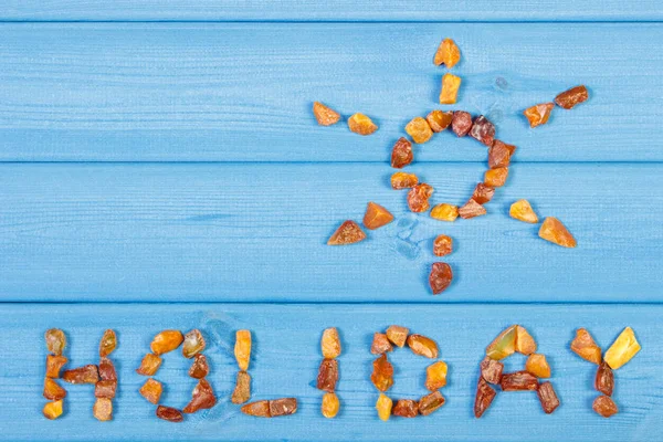 Word holiday and shape of sun on blue boards, concept of vacation time, copy space for text — Stock Photo, Image