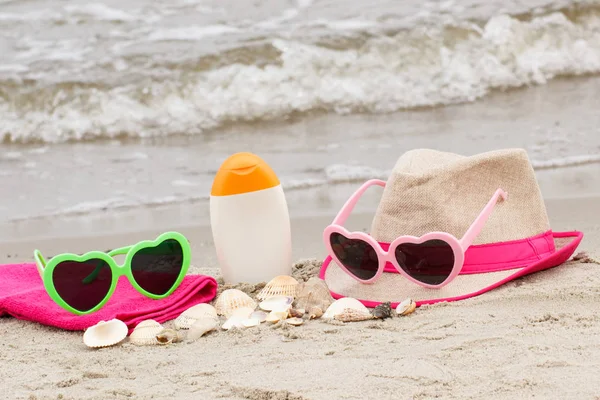 Accessories for vacation on sand at beach, concept of sun protection and summer time — Stock Photo, Image