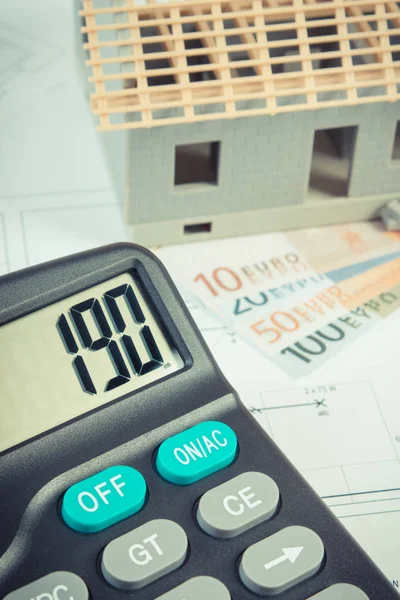House under construction, calculator and currencies euro on electrical drawings and diagrams — Stock Photo, Image