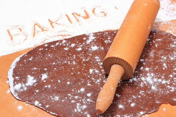 Rolling pin on dough for cookies and word baking — Stock Photo, Image