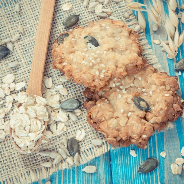 Vintage photo, Fresh baked oatmeal cookies with ingredients for baking and ears of oat, healthy dessert concept — Stock Photo, Image
