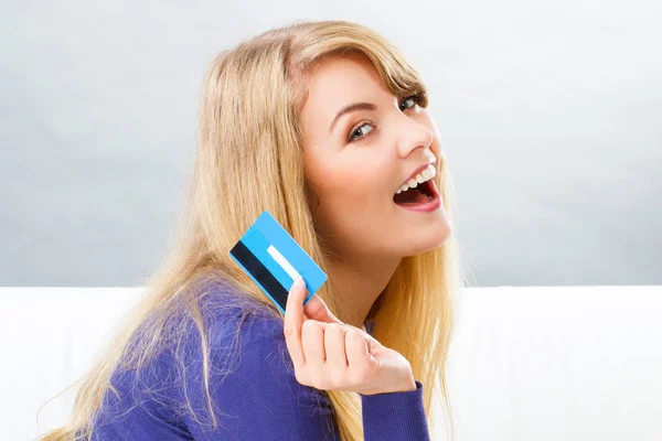 Happy smiling woman with credit card, concept of cashless paying for shopping