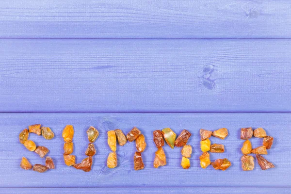 Word summer made of amber stones, copy space for text on boards — Stock Photo, Image