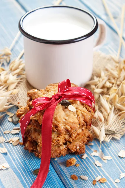 Fresh baked oatmeal cookies, ingredients for baking and ears of oat, healthy dessert concept