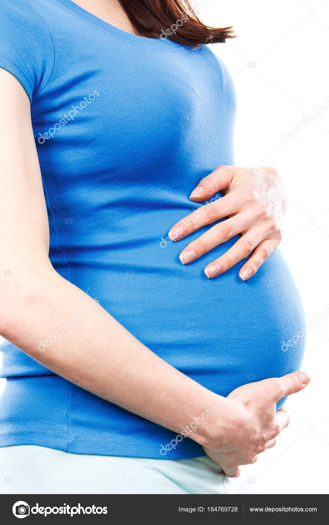 Pregnant woman with stomach pain touching belly, aches in pregnancy and