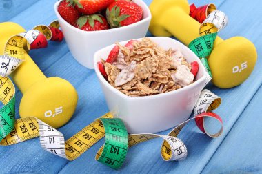 Taze çilek, buğday ve çavdar pul, halter ve santimetre, sağlıklı yaşam konsepti