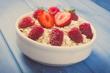 Vintage Fotoğraf, taze yulaf gevreği veya yulaf ezmesi çilek ve ahududu, sağlıklı yaşam ve beslenme