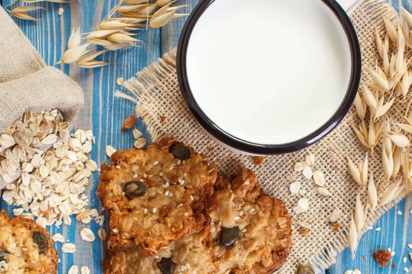 Oatmeal cookies, ingredients for baking and ears of oat, healthy dessert concept