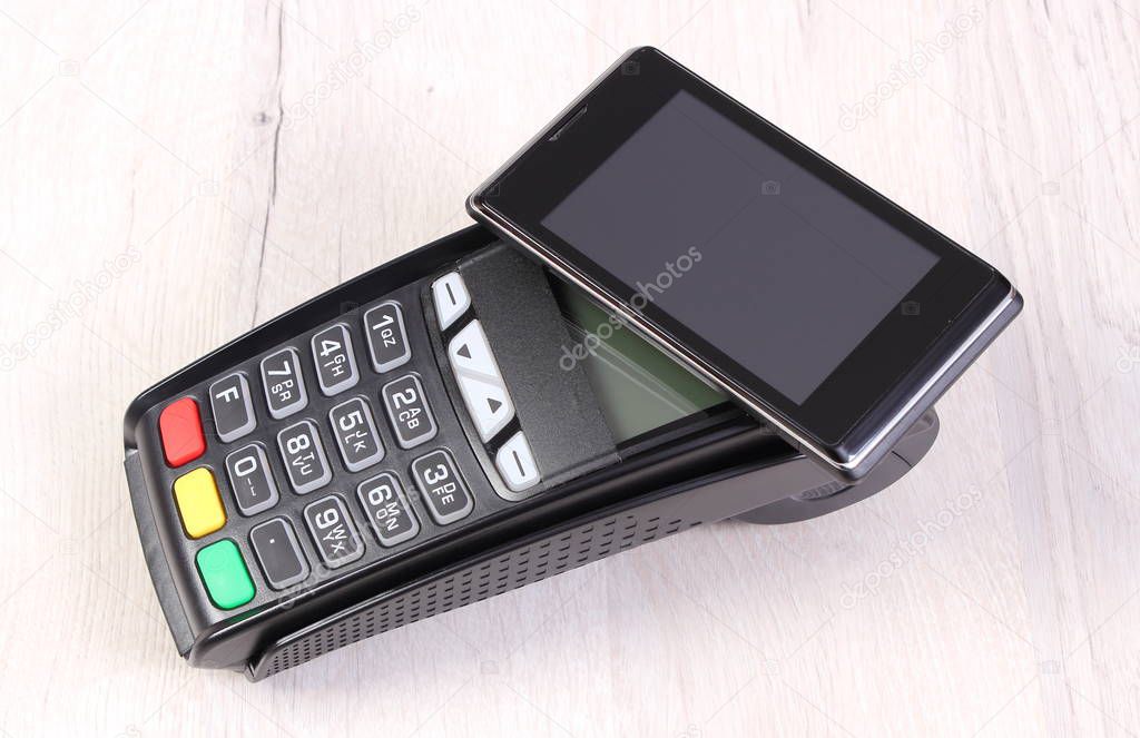 Payment terminal and mobile phone with NFC technology, cashless paying for shopping or products