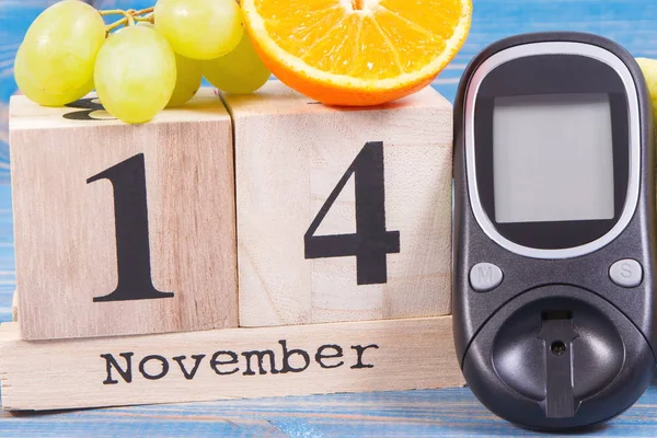 Datum 14. November, Glukosemessgerät und Trauben mit Orange, Konzept zum Weltdiabetestag — Stockfoto