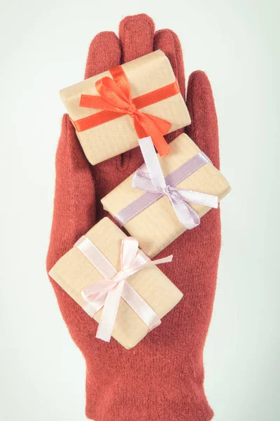 Foto vintage, guantes de mano con regalos para Navidad u otra celebración — Foto de Stock