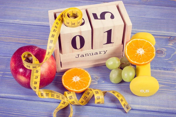 Vintage photo, 1 January on cube calendar, fruits, dumbbells and tape measure, new years resolutions — Stock Photo, Image