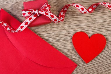 Sevgililer günü için sarılmış hediye, kırmızı kalp ve sevgi mektubu