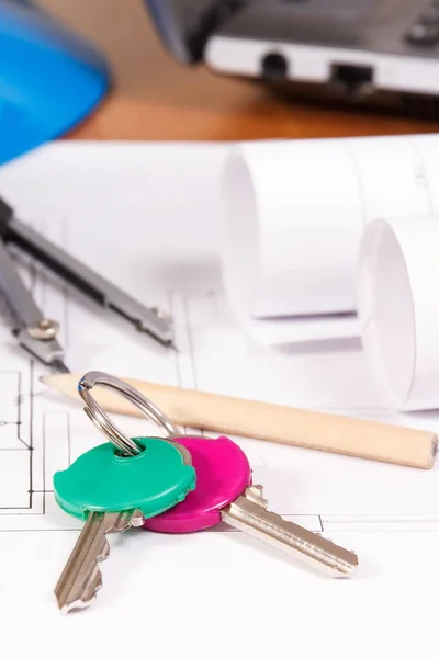 Home keys, electrical diagrams or blueprints and accessories for engineer jobs, building home concept