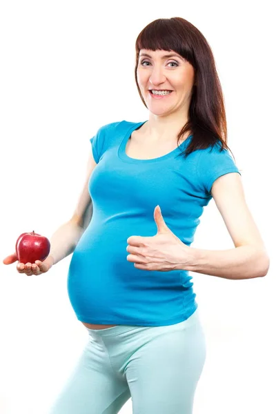 Gelukkig zwangere vrouw houden van verse appel en tonen duimschroef opwaarts, gezonde voeding tijdens de zwangerschap — Stockfoto