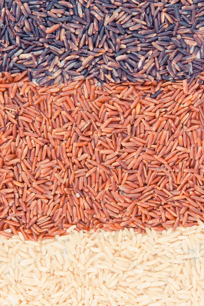 Vintage photo, Heap of brown, red and black rice as background, healthy nutrition concept