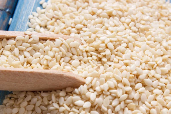 Heap of sesame seeds on wooden boards, healthy food — Stock Photo, Image