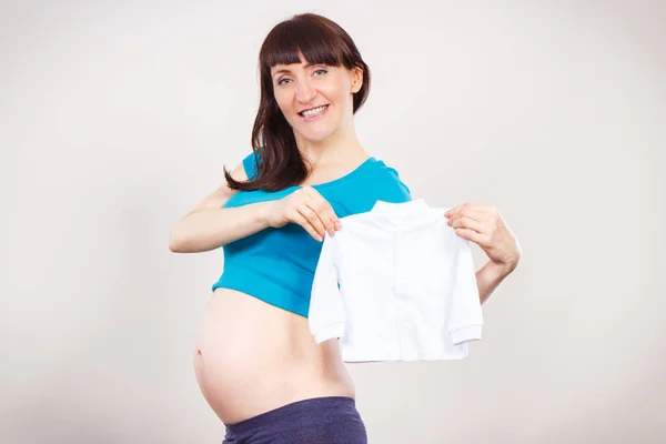 怀孕妇女为新生儿举行衣服, 期待婴儿 — 图库照片