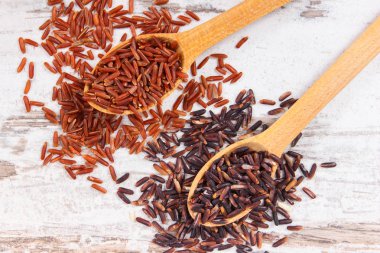 Tahta kaşık, sağlıklı beslenme kavramı kırmızı ve siyah pirinç