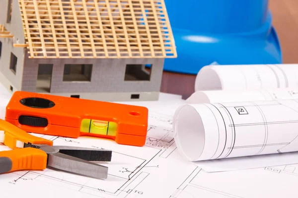 Diagramas eléctricos, herramientas de trabajo, casco para trabajos de ingeniería y casa en construcción, concepto de casa de construcción — Foto de Stock