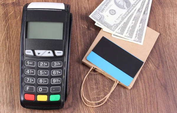 Payment terminal with credit card, currencies dollar and paper shopping bag — Stock Photo, Image