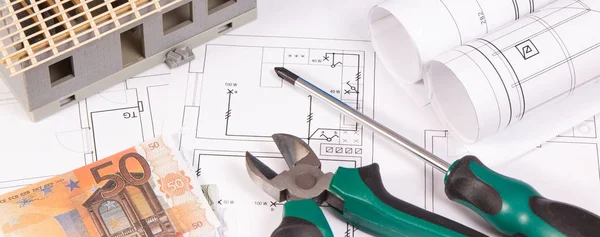 Electrical diagrams, work tools for engineer jobs, house under construction and currencies euro, building home cost concept