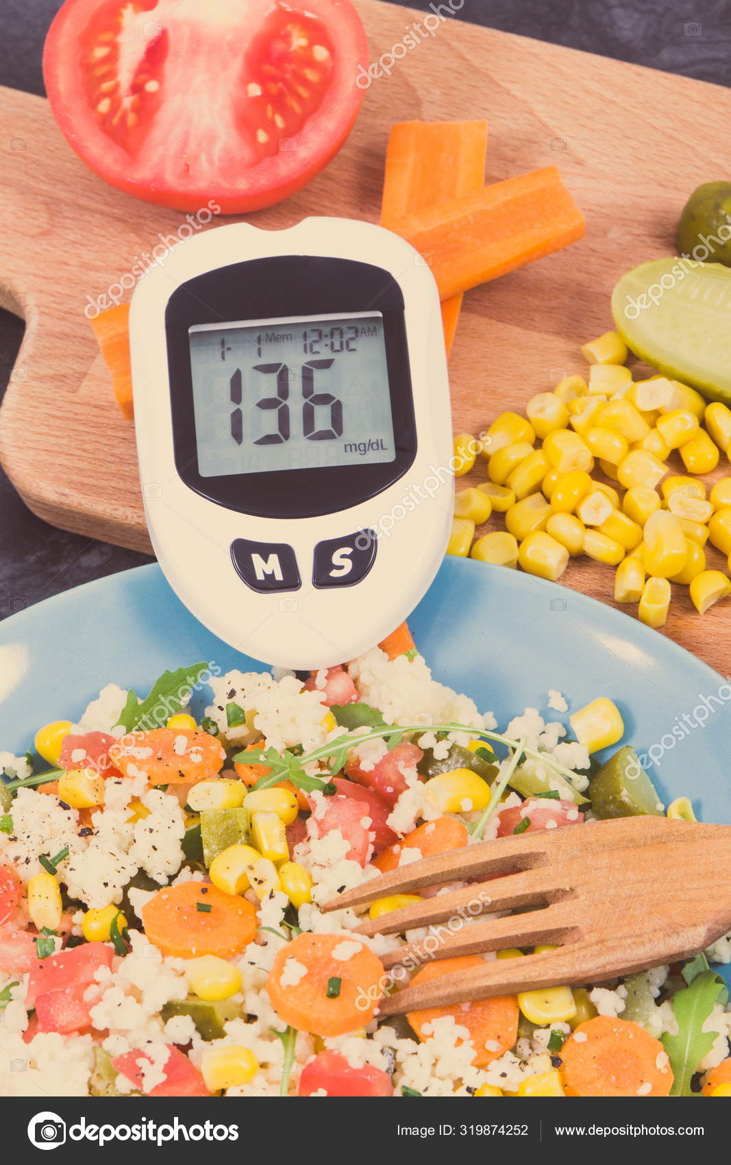 Glucose meter with result sugar level and salad with couscous and