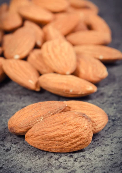 Almonds as source minerals and fiber. Wooden background — Stock Photo, Image