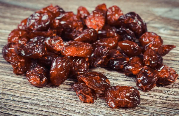 Cranberries as source minerals and fiber. Wooden background — Stock Photo, Image