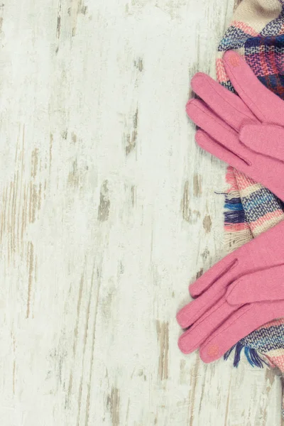 Womanly pink gloves and colorful shawl for autumn or winter, copy space for text
