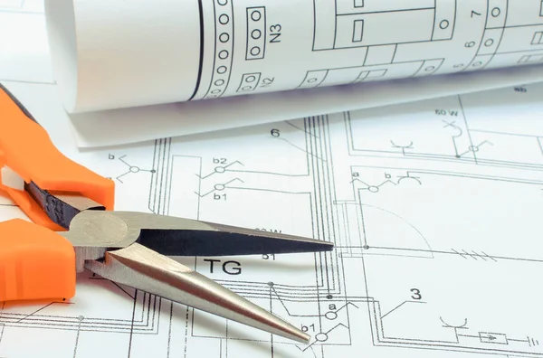 Electrical diagrams and pliers on construction drawing of house. Building home concept — Stock Photo, Image