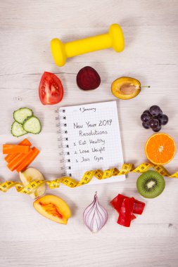 Fruits and vegetables, dumbbell for fitness and centimeter, new year resolutions of healthy lifestyles and slimming