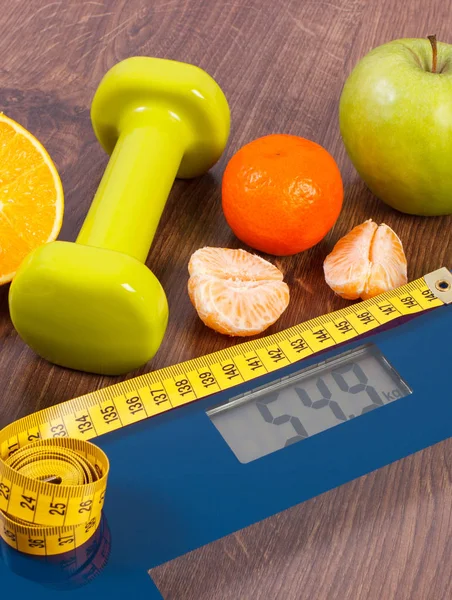 Digital scale with tape measure, dumbbells and fruits. Slimming concept — Stock Photo, Image