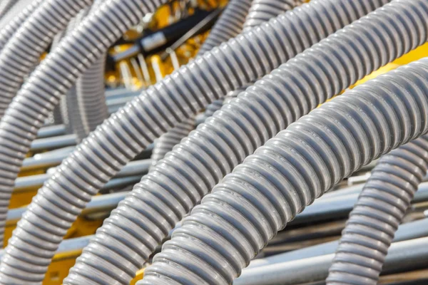 Plastic corrugated pipes in agricultural or industrial machinery. Part of hydraulic or pneumatic equipments. Technology concept — Stock Photo, Image