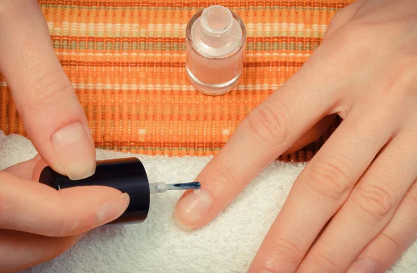 Nail polish applied to hand of woman. Care of hands concept — Stock Photo, Image