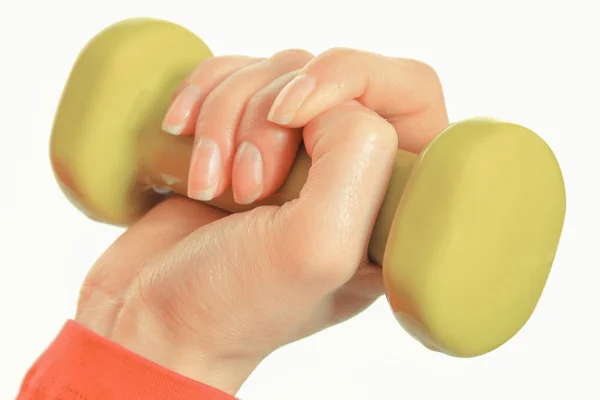 Hand van een vrouw met halters op een witte achtergrond. Gezonde fitness oefening — Stockfoto