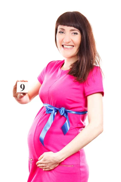 妊娠中の女性は妊娠、新生児用を期待しての概念の 9 番目の月の数を示す — ストック写真