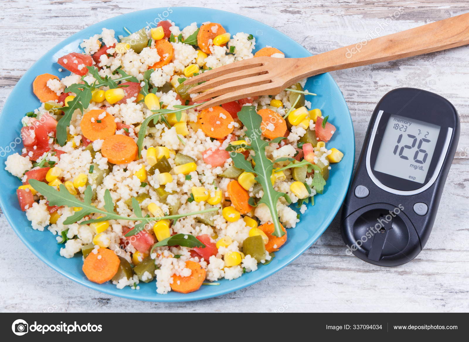 Glucose meter for checking sugar level and salad with vegetables and