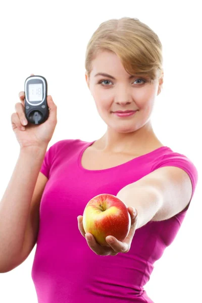Happy woman holding glucometer for checking sugar level and fresh apple — Stock Photo, Image